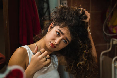 Portrait of beautiful young woman sitting at home