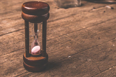 Close-up of hourglass on wooden table