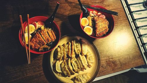 High angle view of food in plate and bowls on table