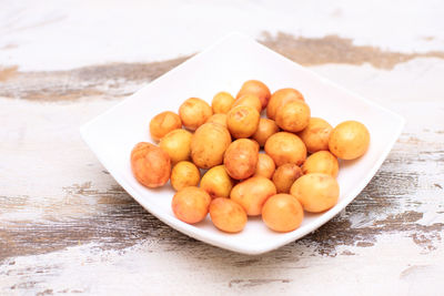 High angle view of fruits in plate on table