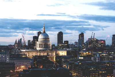 View of cityscape against cloudy sky