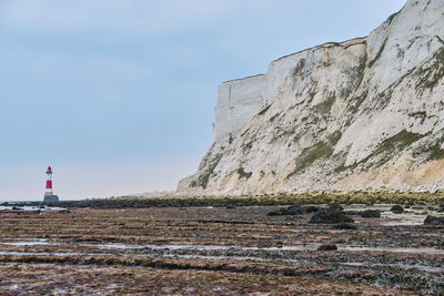 Beachy head lighthouse, seven sisters chalk cliffs at low tide near eastbourne, east sussex.