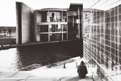 Rear view of people standing in front of building