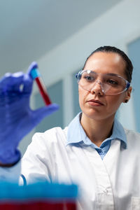 Scientist holding test tube at lab