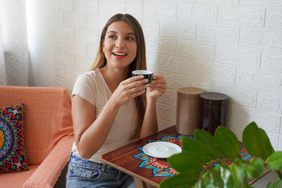 Coffee ads. beautiful young woman drinking coffee at home in the morning. 