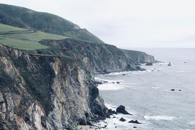 Scenic view of sea and mountains against sky