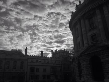 Low angle view of building against cloudy sky