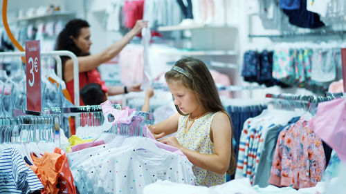 Shopping in the store. children's clothing department. girl, kid, chooses things in the store. 