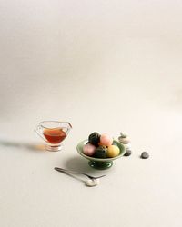 Three color kkultteok is ball shaped rice cake filled with honey and sesame syrup.