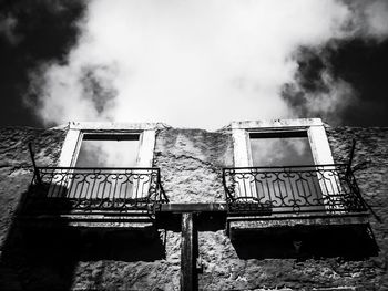 Low angle view of old abandoned building against sky