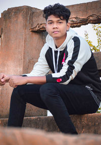 Portrait of young man sitting outdoors