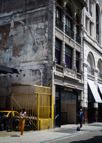 People walking on street by building
