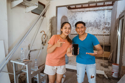 Portrait of smiling couple standing in factory
