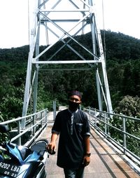 Man standing on footbridge