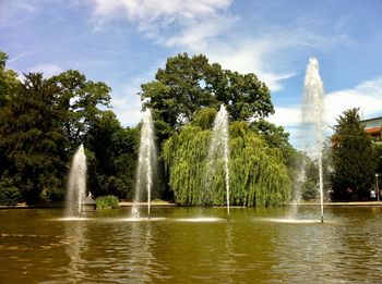 View of fountain in lake against sky