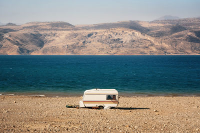 Scenic view of sea against mountain range