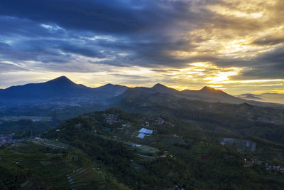 High angle shot of townscape against sunset sky