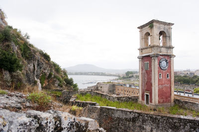 Clock tower amidst buildings against sky