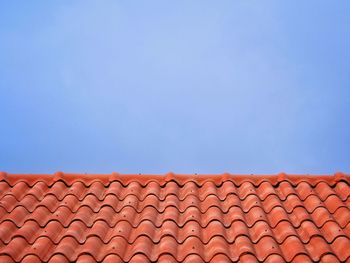 Low angle view of roof tiles against sky