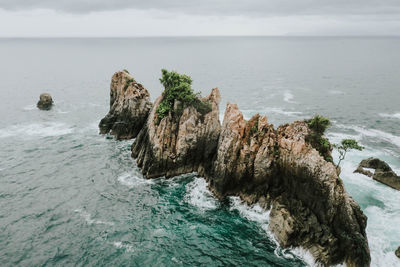 Panoramic view of rocks in sea against sky