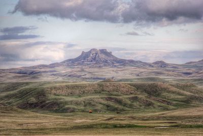 Scenic view of mountains against cloudy sky