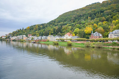 Scenic view of lake by buildings against sky