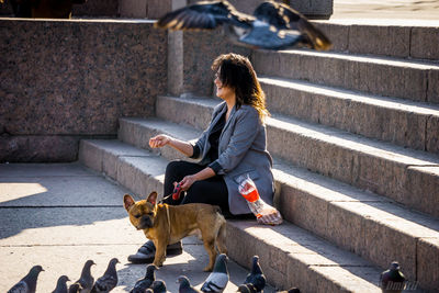 Woman with dog on staircase