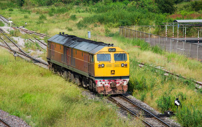 Train on railroad track amidst field