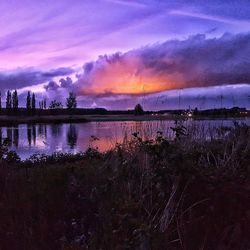 View of calm lake against scenic sky