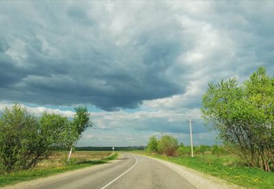 Empty road along countryside landscape