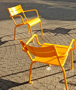 High angle view of empty chairs and tables on street