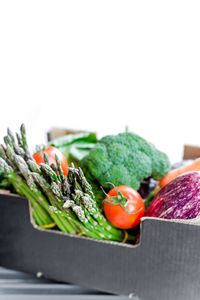 Close-up of vegetables and red bell peppers on white background