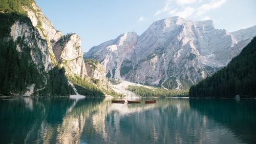 Scenic view of lake by mountains against sky