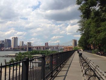 Bridge against cloudy sky