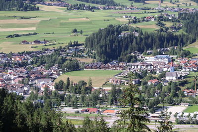High angle view of townscape and trees on field