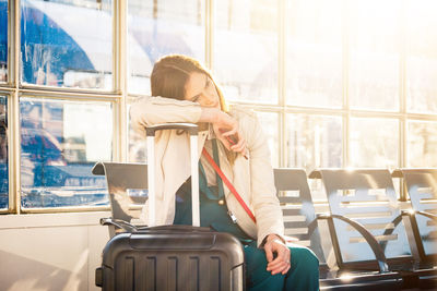 Tired woman waiting at airport lounge