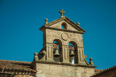 Low angle view of historic building against clear blue sky