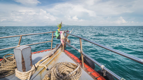 Fishing boat in sea against sky