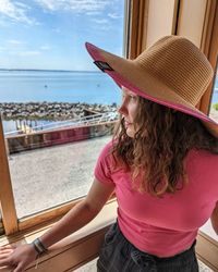 Rear view of woman looking at sea against sky