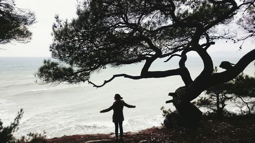 Silhouette of woman standing on beach