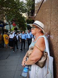 Side view of people on street in city