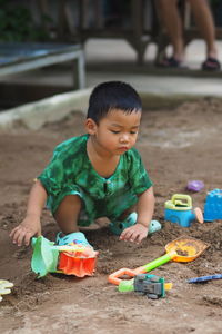 Portrait of boy playing with toys