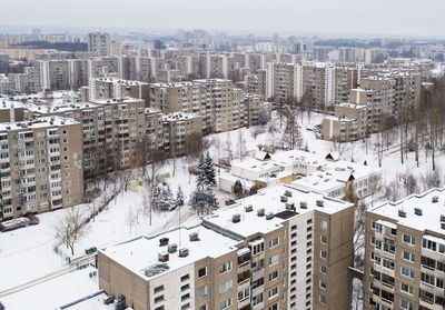 High angle view of snow covered buildings in city