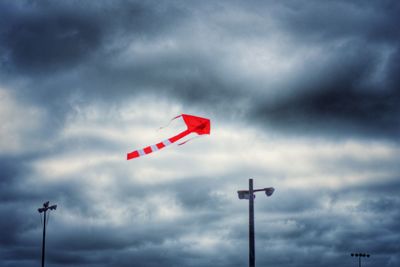 Low angle view of street light against cloudy sky