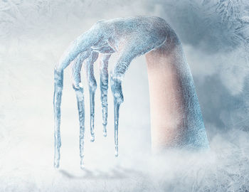 Close-up of human hand on snow