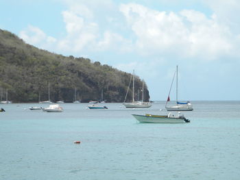Boats moored on sea against sky