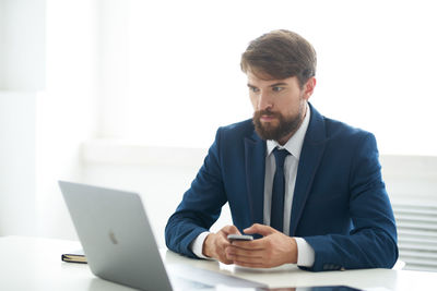 Mid adult man using mobile phone