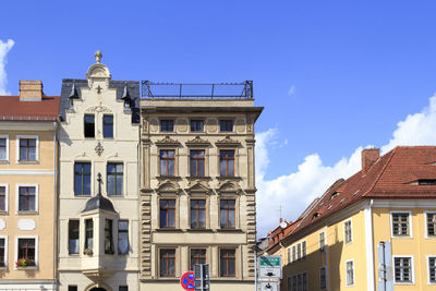 Low angle view of houses against blue sky