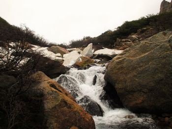 Close-up of waterfall against sky