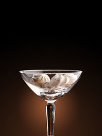 Close-up of beer glass against black background